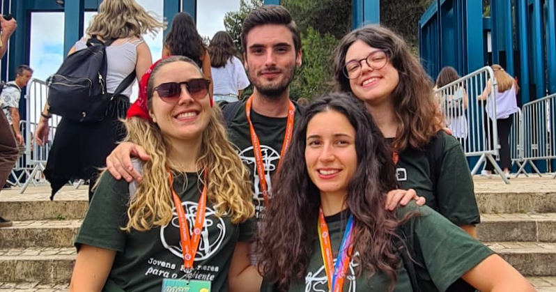 foto de 4 jovens, um rapaz e duas raparigas em pé numas escadas num festival